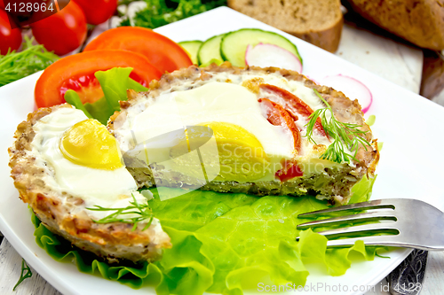 Image of Tartlet meat with egg cut and vegetables on light board