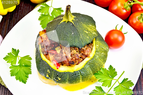 Image of Squash green stuffed with meat on dark board