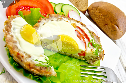 Image of Tartlet meat with egg cut on board