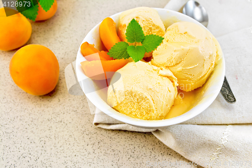 Image of Ice cream apricot in white bowl on napkin