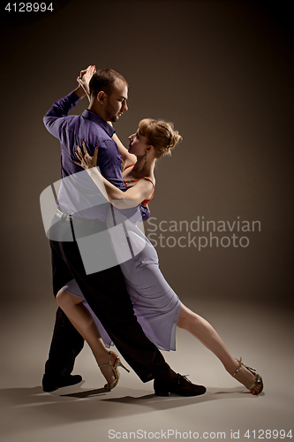 Image of The man and the woman dancing argentinian tango