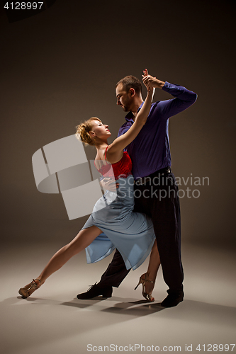 Image of The man and the woman dancing argentinian tango