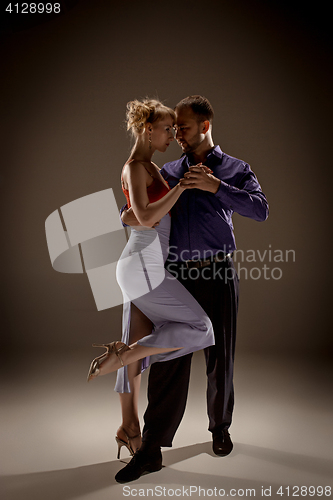 Image of The man and the woman dancing argentinian tango