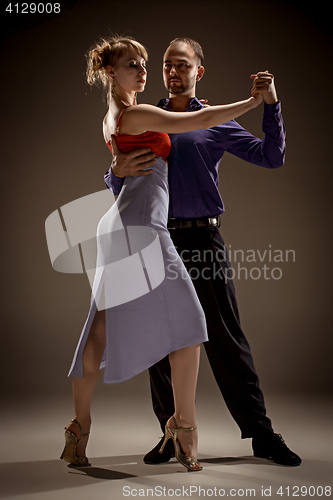 Image of The man and the woman dancing argentinian tango