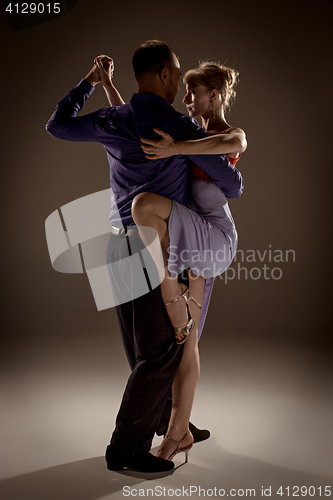 Image of The man and the woman dancing argentinian tango
