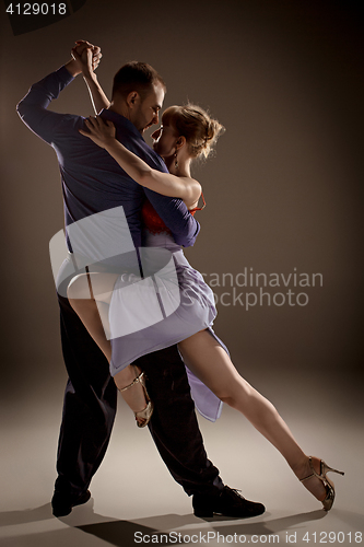 Image of The man and the woman dancing argentinian tango