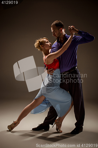 Image of The man and the woman dancing argentinian tango