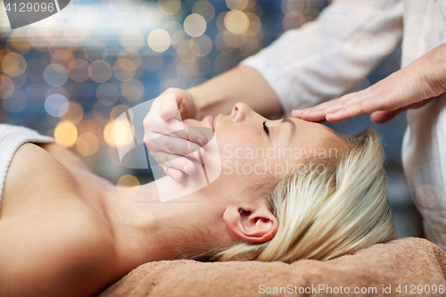 Image of close up of woman having face massage in spa