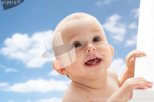 Image of happy little baby boy or girl looking up