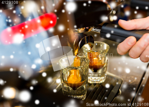 Image of close up of woman doing espresso by coffee machine