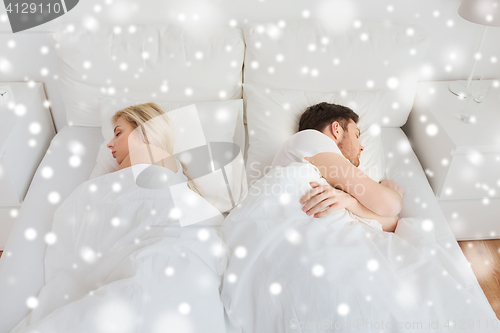 Image of couple sleeping in bed at home