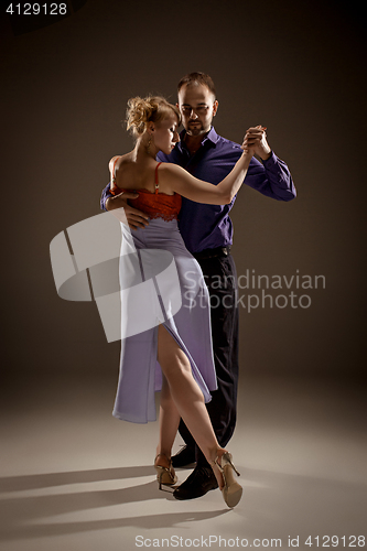 Image of The man and the woman dancing argentinian tango