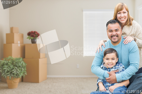 Image of Mixed Race Family with Son in Room with Packed Moving Boxes