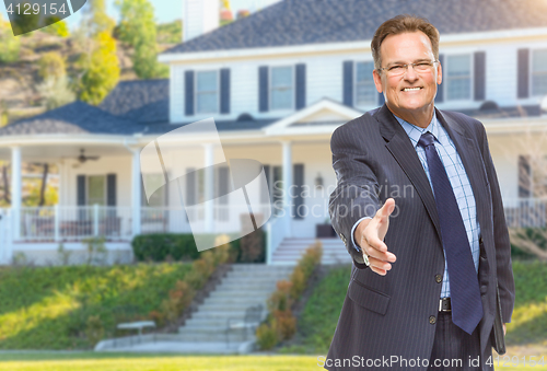 Image of Male Agent Reaching for Hand Shake in Front of House