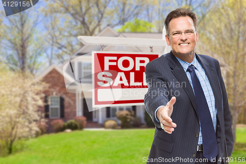 Image of Male Agent Reaching for Hand Shake in Front of House and For Sal