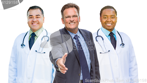 Image of Mixed Race Doctors Behind Businessman Reaching for Hand Shake on