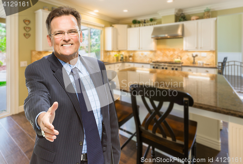 Image of Male Agent Reaching for Hand Shake in New Kitchen