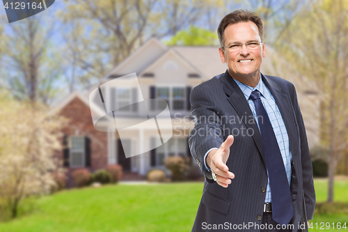 Image of Male Agent Reaching for Hand Shake in Front of House