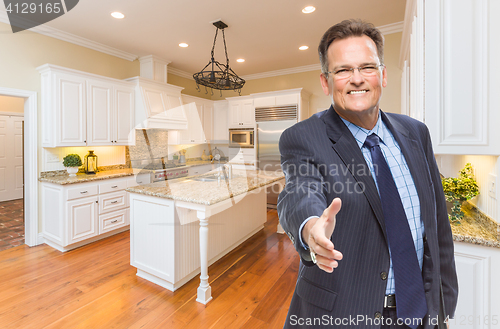 Image of Male Agent Reaching for Hand Shake in New Kitchen