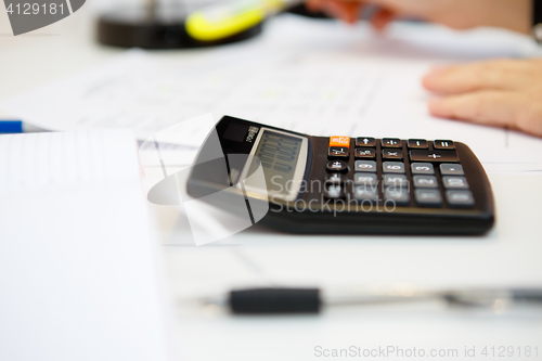 Image of Accountant executes report on table