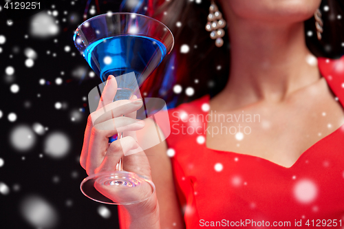 Image of close up of beautiful woman with cocktail at night