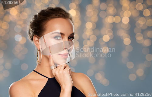 Image of beautiful woman in black wearing diamond jewelry