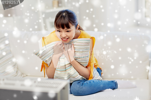 Image of happy asian young woman watching tv at home