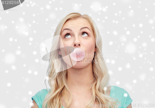 Image of happy young woman or teenage girl chewing gum