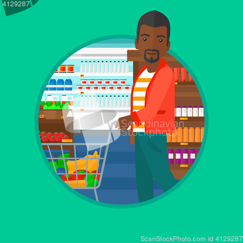 Image of Customer with shopping trolley at supermarket.