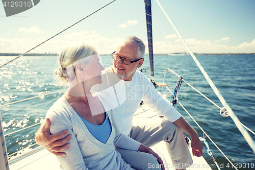 Image of senior couple hugging on sail boat or yacht in sea