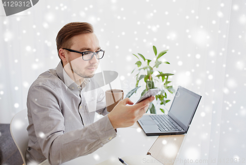 Image of businessman with smarphone and coffee