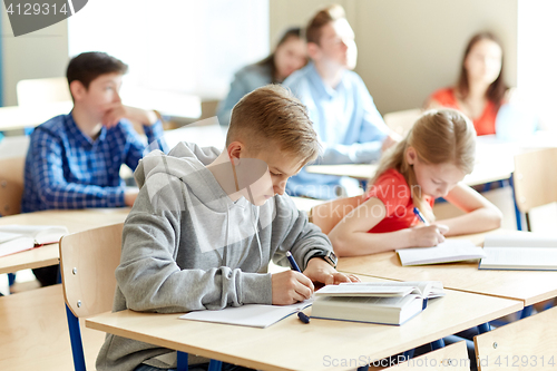 Image of group of students with books writing school test