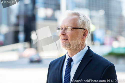 Image of senior businessman on city street