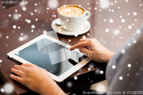 Image of woman with tablet pc and coffee cup