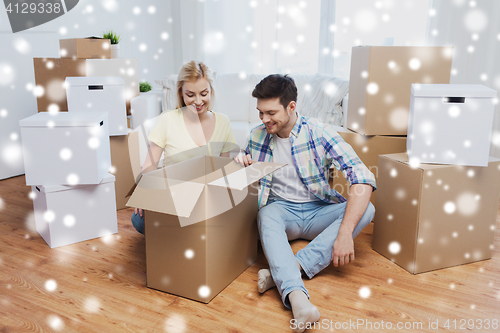 Image of smiling couple with big boxes moving to new home