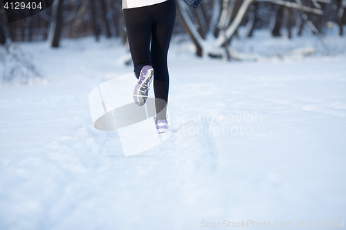 Image of Young sportswoman engaged in running