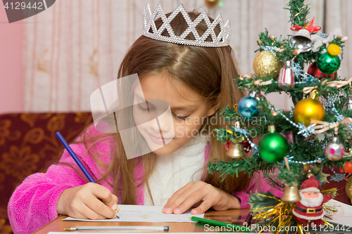 Image of A girl waiting for a new year, writes a letter to the desires