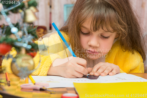 Image of Carried away by a girl making Christmas crafts