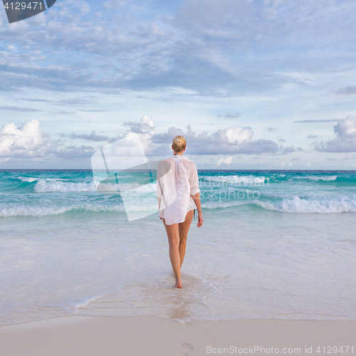 Image of Woman on summer vacations at tropical beach of Mahe Island, Seychelles.