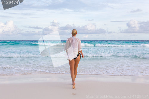 Image of Woman on summer vacations at tropical beach of Mahe Island, Seychelles.