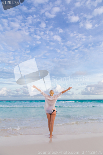 Image of Woman enjoying Anse Lazio picture perfect beach on Mahe Island, Seychelles.