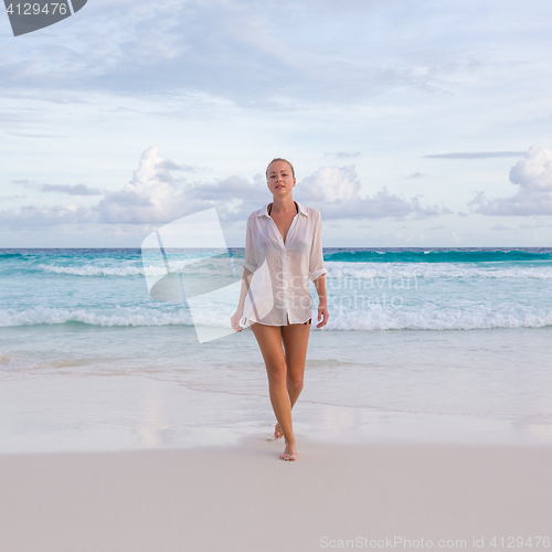 Image of Woman on summer vacations at tropical beach of Mahe Island, Seychelles.