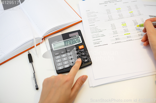 Image of Accountant performs report on desk