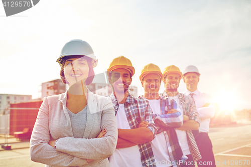 Image of happy builders and architect at construction site