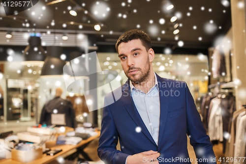 Image of young handsome man in jacket at clothing store