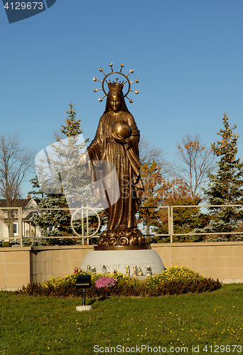 Image of A tall bronze statue of Mother Mary.