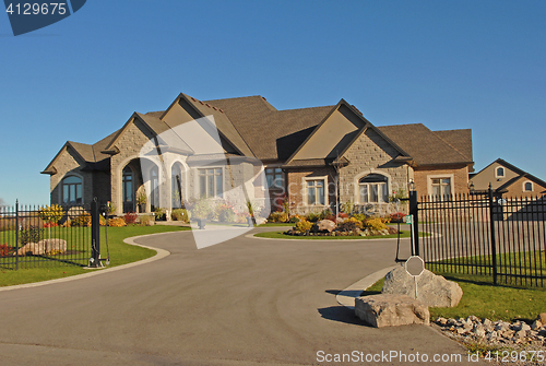 Image of Large mansion with driveway.