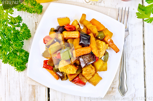 Image of Roast with vegetables and honey in plate on board top