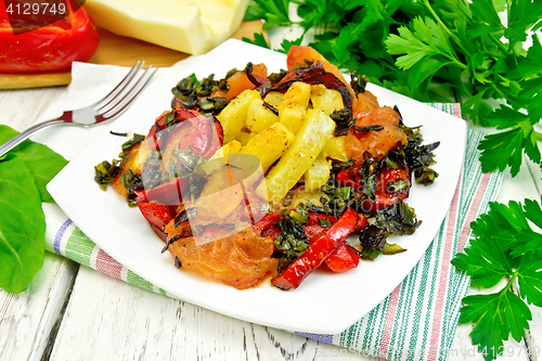 Image of Courgettes with vegetables in plate on table