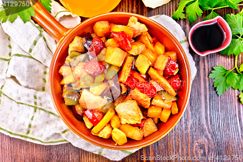 Image of Roast with vegetables and honey in pan on board top